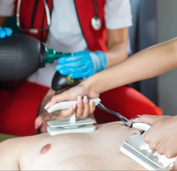 paramedic-using-defibrillator-aed-conducting-basic-cardiopulmonary-resuscitation-emergency-care-assistant-putting-silicone-manual-resuscitators-ambulance-scaled-e1691293098126